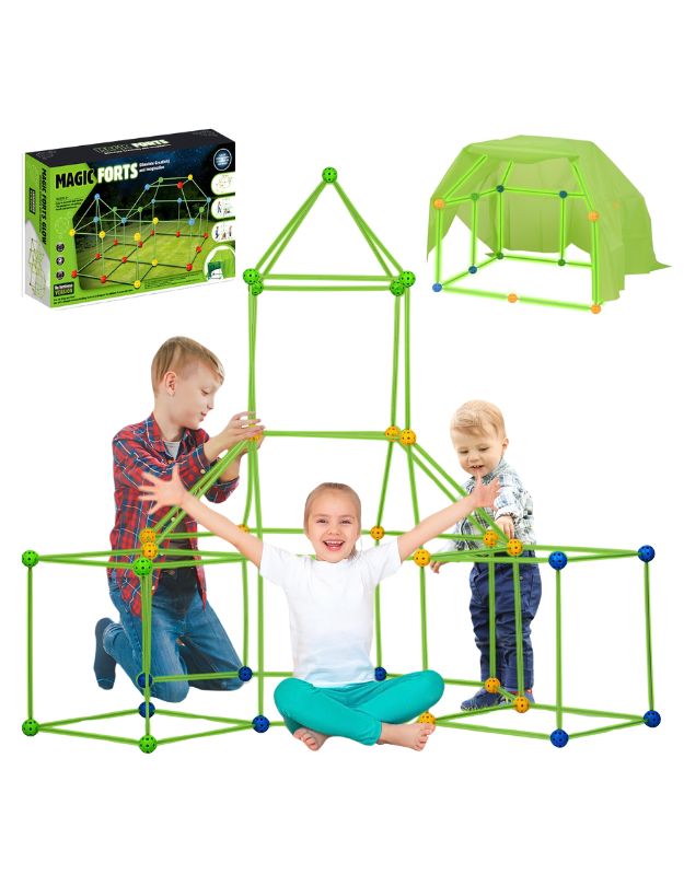 Children playing with a green tent building kit that includes poles and a blanket, with the box packaging visible in the background.